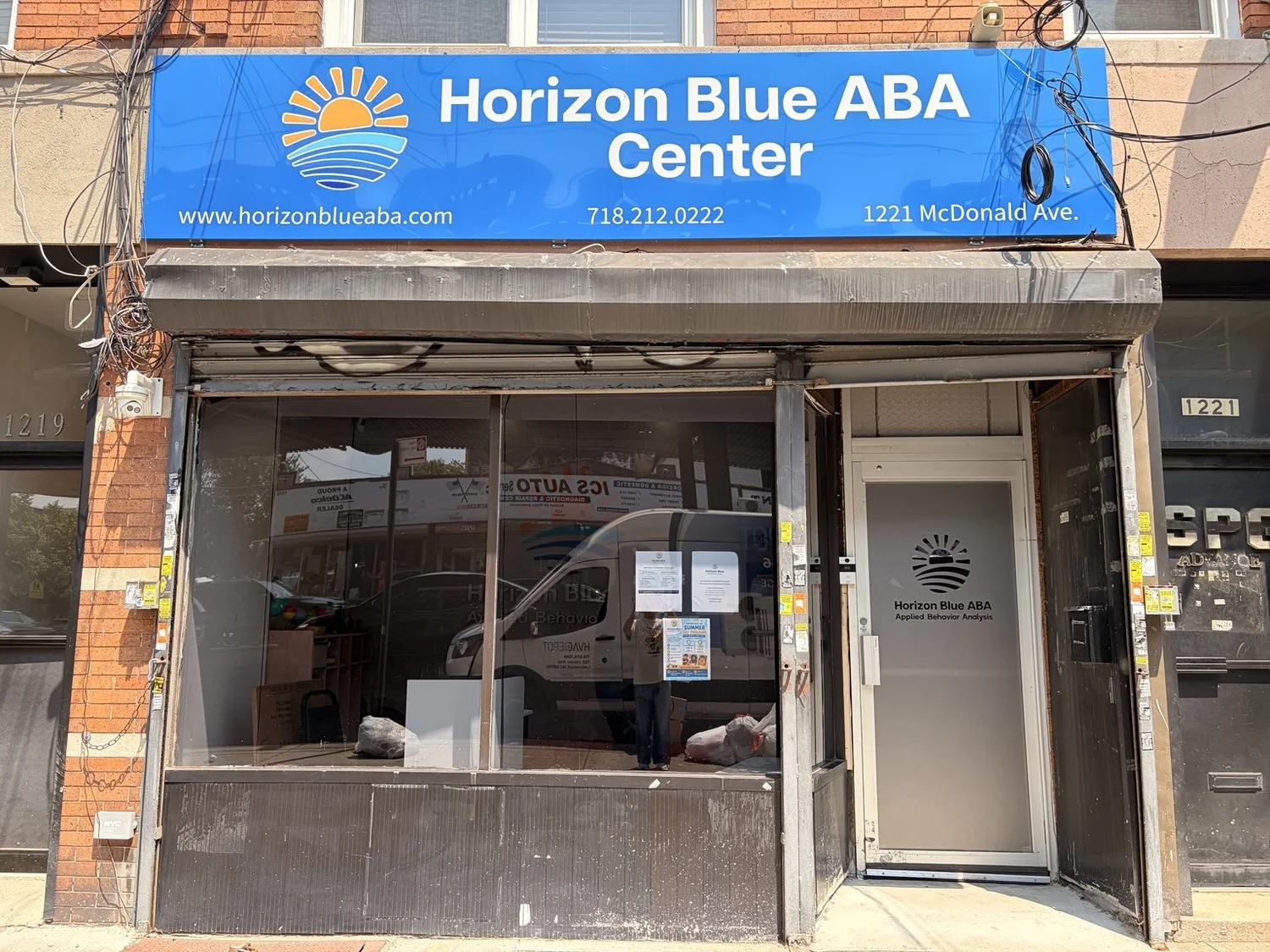 Storefront of the Horizon Blue ABA Brooklyn Center with a blue sign and glass entrance