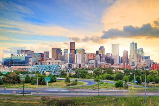 The Denver, Colorado skyline with the Rocky Mountains behind it